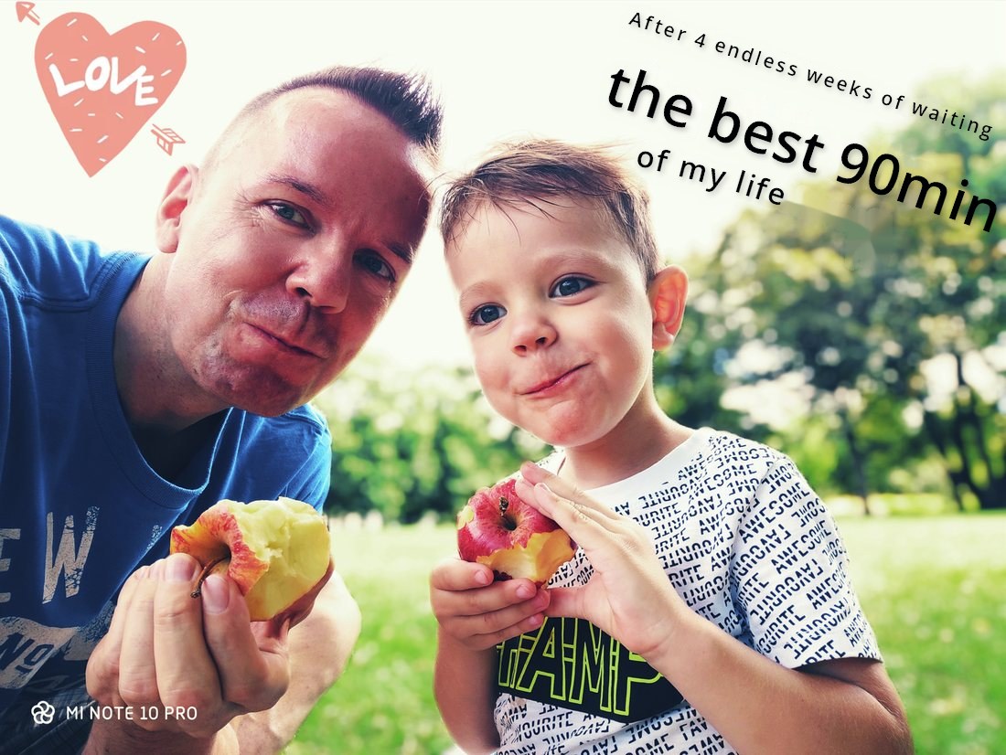 The father and his son in a park, each holding a bitten apple. The photo carries the words: After 4 endless weeks of waiting — the best 90min of my life.